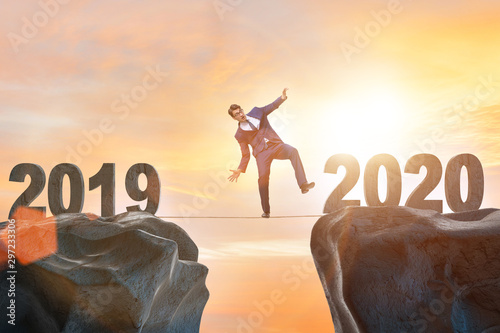 Businessman on tight rope from year 2019 to 2020