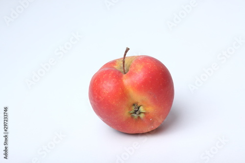 Concept of ugly food - red apple on white background