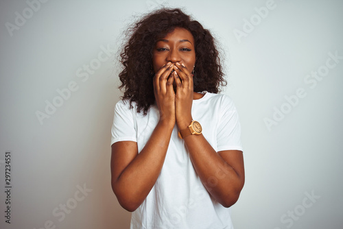 Принти на полотні Young african american woman wearing t-shirt standing over isolated white backgr