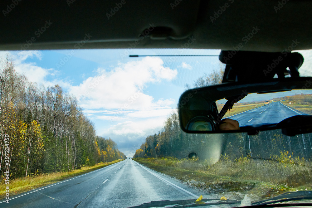 Track from the car window and white clouds on blue sky. Natural landscape Track from the car window and white clouds on blue sky. Natural landscape