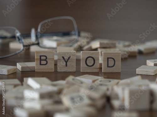 The acronym Byod of Bring Your Own Device represented by wooden letter tiles photo