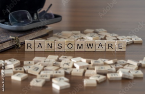 The concept of Ransomware represented by wooden letter tiles