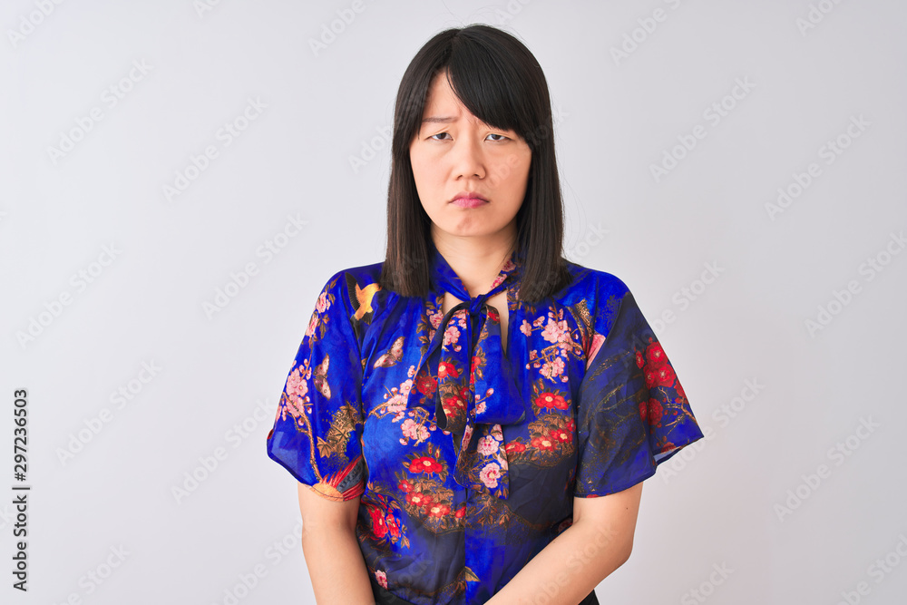 Young beautiful chinese woman wearing summer floral t-shirt over isolated white background skeptic and nervous, frowning upset because of problem. Negative person. Young beautiful chinese woman wearing summer floral t-shirt over isolated white background skeptic and nervous, frowning upset because of problem. Negative person.