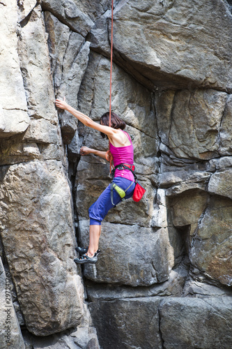 Rock climber is training on natural terrain.