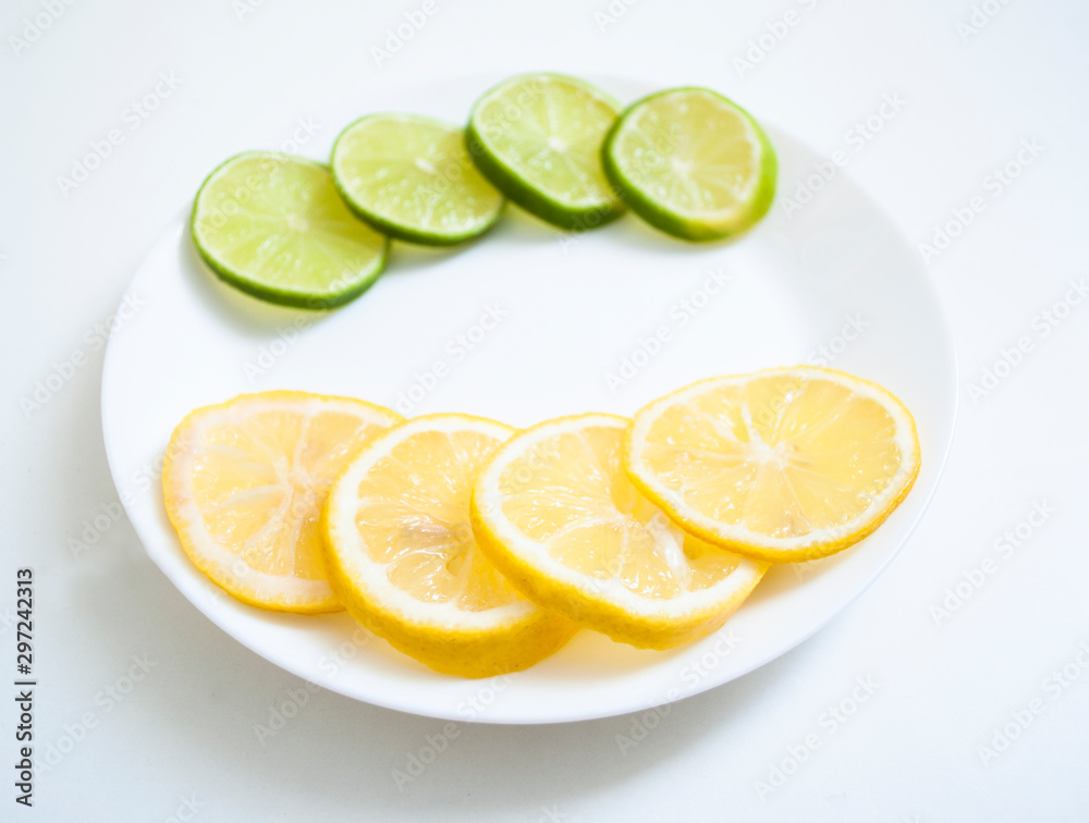 slices of lemon and lime on a white plate horizontally