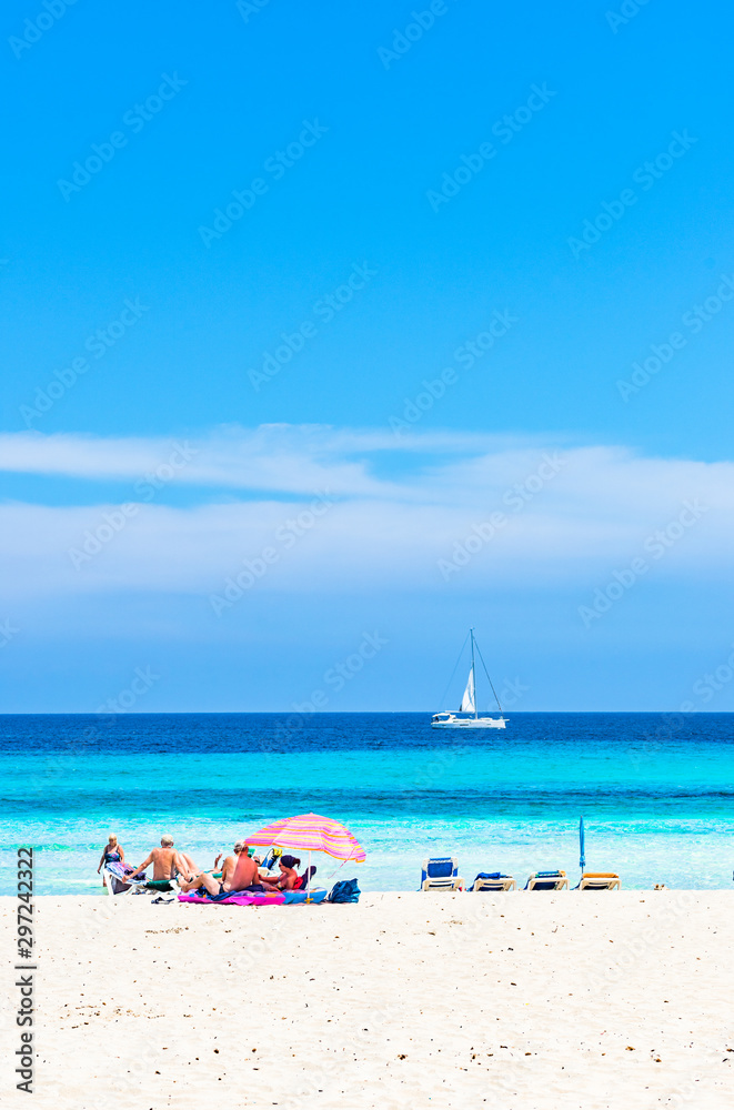 Tourists at beautiful sand beach of seaside at tourist resort Cala Millor, Mallorca island, Spain Balearic Islands