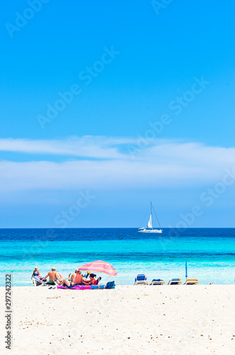 Tourists at beautiful sand beach of seaside at tourist resort Cala Millor  Mallorca island  Spain Balearic Islands