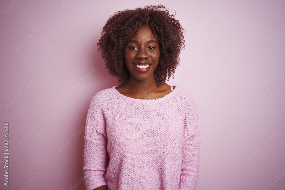 Young african afro woman wearing sweater standing over isolated pink background with a happy and cool smile on face. Lucky person. Young african afro woman wearing sweater standing over isolated pink background with a happy and cool smile on face. Lucky person.