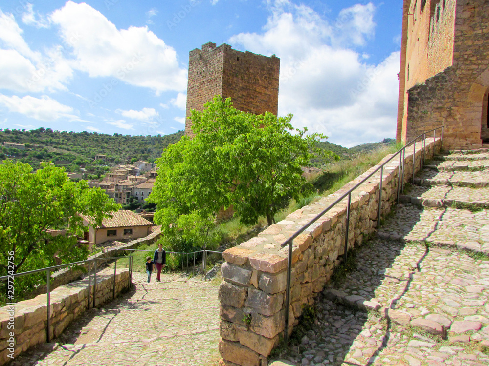 Tourist family mother and son on the street of medieval town Alquezar, Aragon, Spain