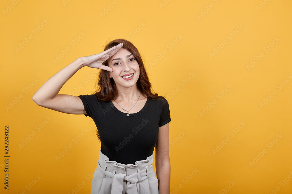 Girl doing military practice as she is saluting to her commanding officer in a frank way. She is happy as she is ready to follow someone's orders precisely. Girl doing military practice as she is saluting to her commanding officer in a frank way. She is happy as she is ready to follow someone's orders precisely.