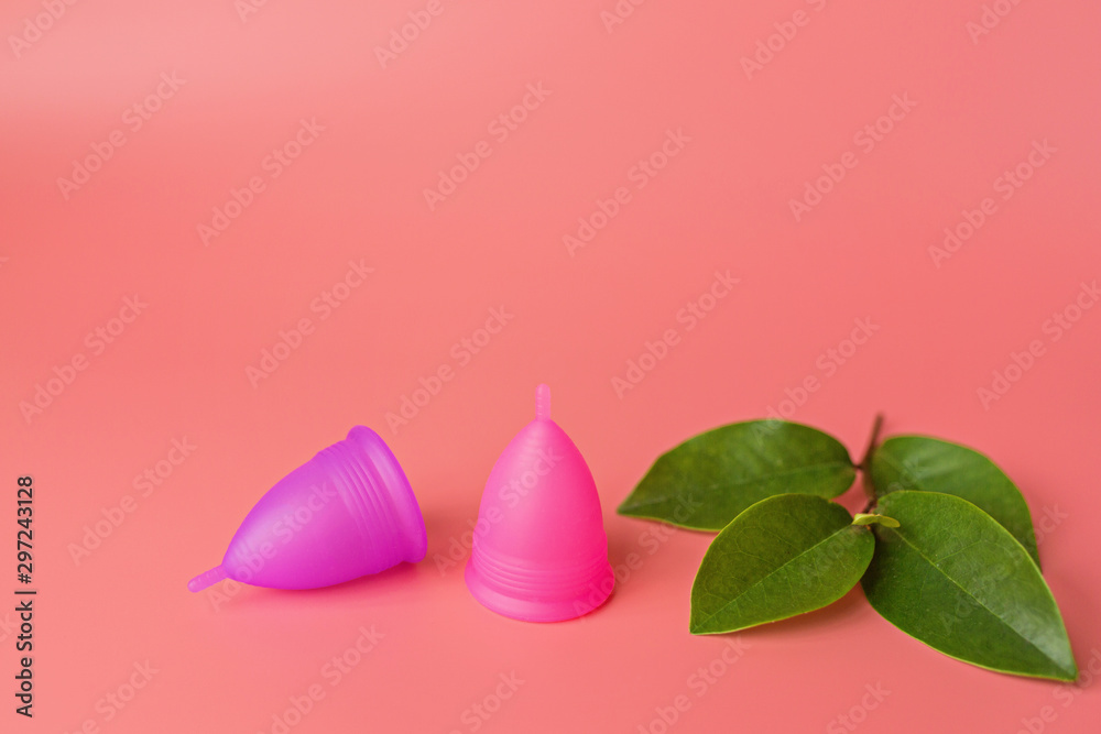 Menstrual cups on pink background. Alternative feminine hygiene product during the period. Women health concept. Copy space. Eco friendly concept, zero waste product. mockup, template Menstrual cups on pink background. Alternative feminine hygiene product during the period. Women health concept. Copy space. Eco friendly concept, zero waste product. mockup, template