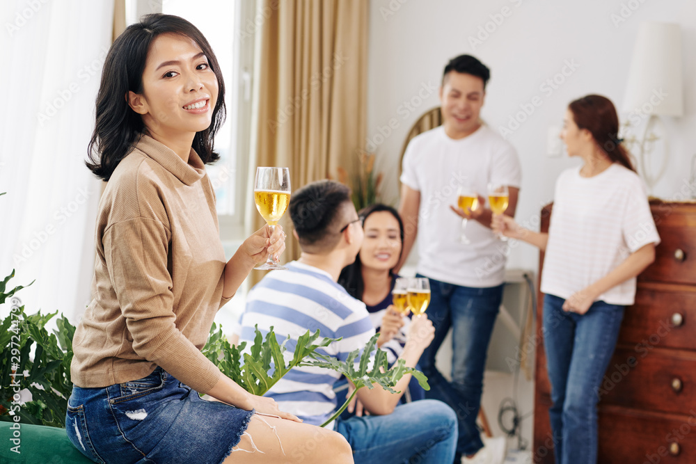 Beautiful young Asian woman drinking sparkling wine at home party Beautiful young Asian woman drinking sparkling wine at home party