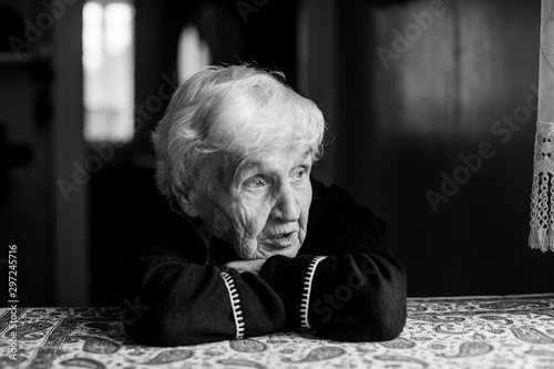 Lonely sad old woman. Black and white photo.
