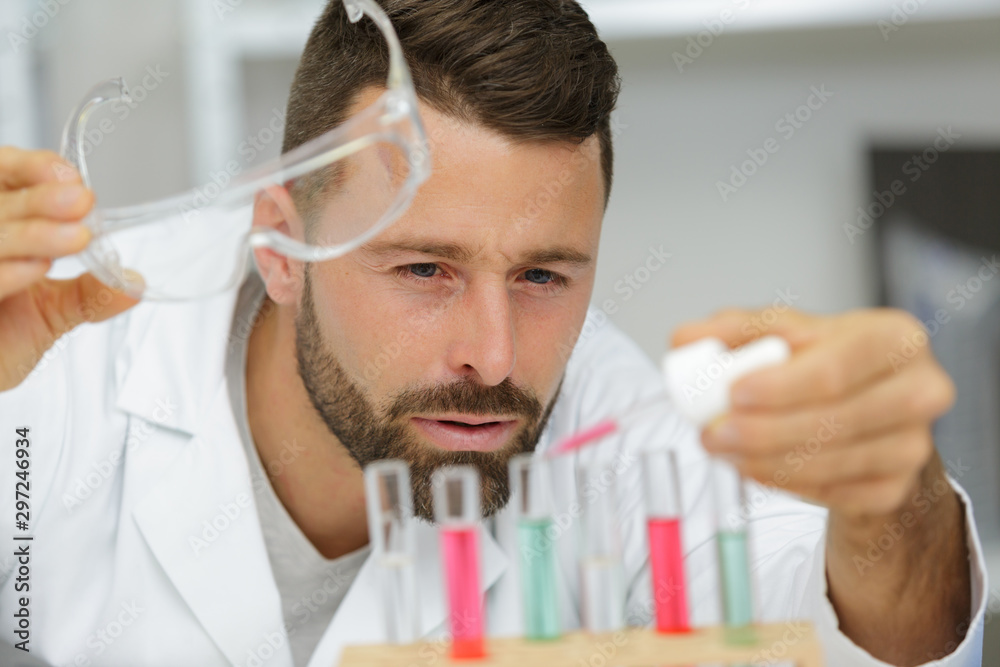 scientist holding an eppendorf tube and pipette scientist holding an eppendorf tube and pipette