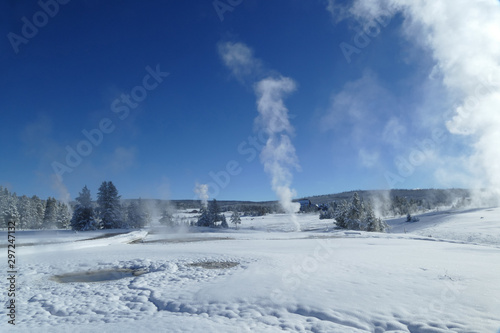 Yellowstone landscape with geyser and snow during winter