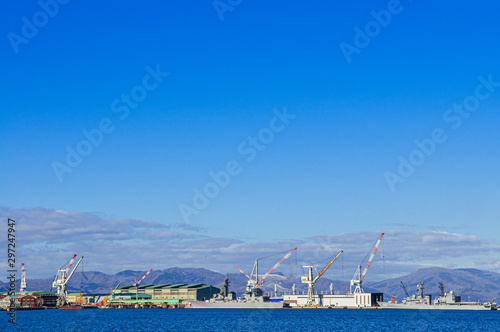 Hakodate blue harbour bay and industrial port with large cranes and ship