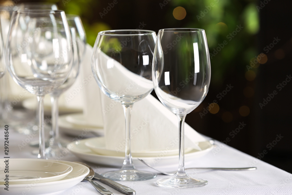 Table setting with empty glasses, plates and cutlery indoors Table setting with empty glasses, plates and cutlery indoors