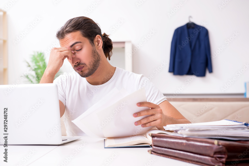 Young male student preparing for exams at home Young male student preparing for exams at home