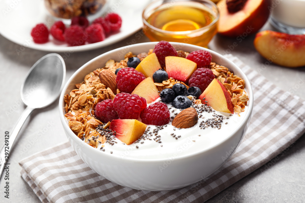 Tasty homemade granola with yogurt served on grey table. Healthy breakfast Tasty homemade granola with yogurt served on grey table. Healthy breakfast