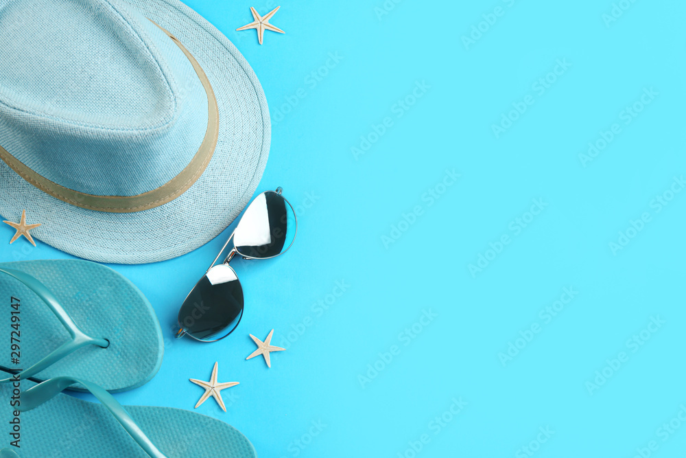 Flat lay composition with sunglasses and beach accessories on blue background. Space for text - obrazy, fototapety, plakaty 