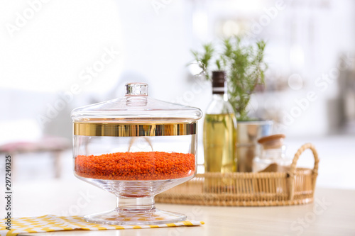 Red lentil on wooden table in modern kitchen