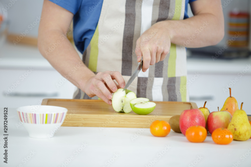 he is slicing varieties of fruits he is slicing varieties of fruits