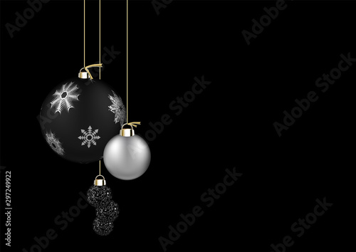 Christmas balls isolated on black background. Festive xmas and New Year background decoration black and silver bauble with snowflakes, hanging on the ribbon.
