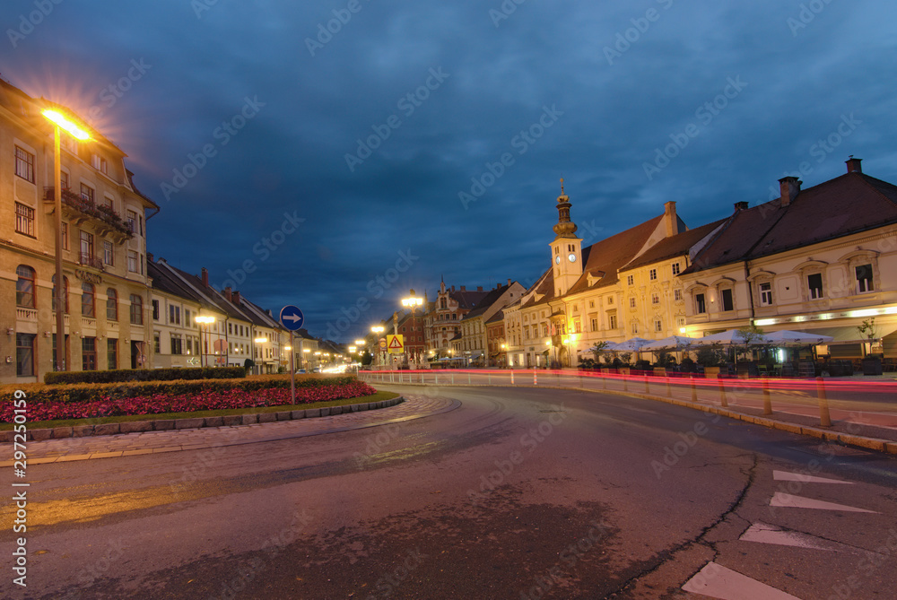 Maribor, Slovenia-September 24, 2019: Morning view of medieval buildings against vibrant autumn sky. The Rotovz Town Hall Square in Maribor. Famous touristic place and travel destination in Slovenia