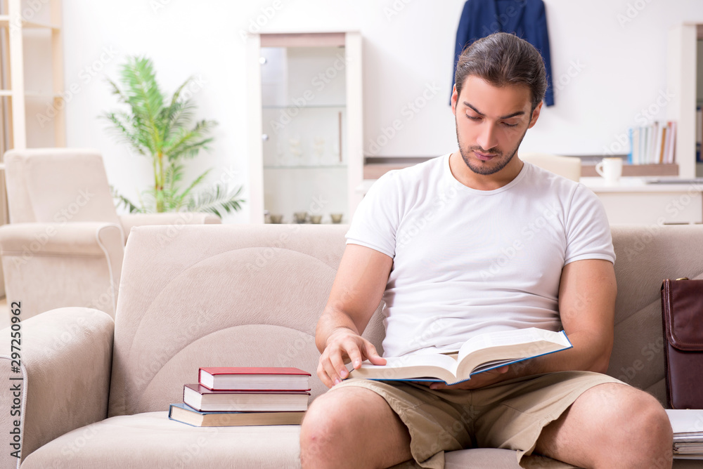 Young male student preparing for exams at home Young male student preparing for exams at home