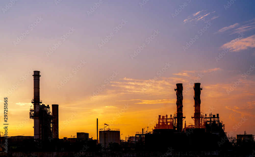 Gas turbine electrical power plant. Energy for support factory in industrial estate. Natural gas tank. Small gas power plant. Power plant using natural gas for fuel. Green energy. Dramatic sunset sky.
