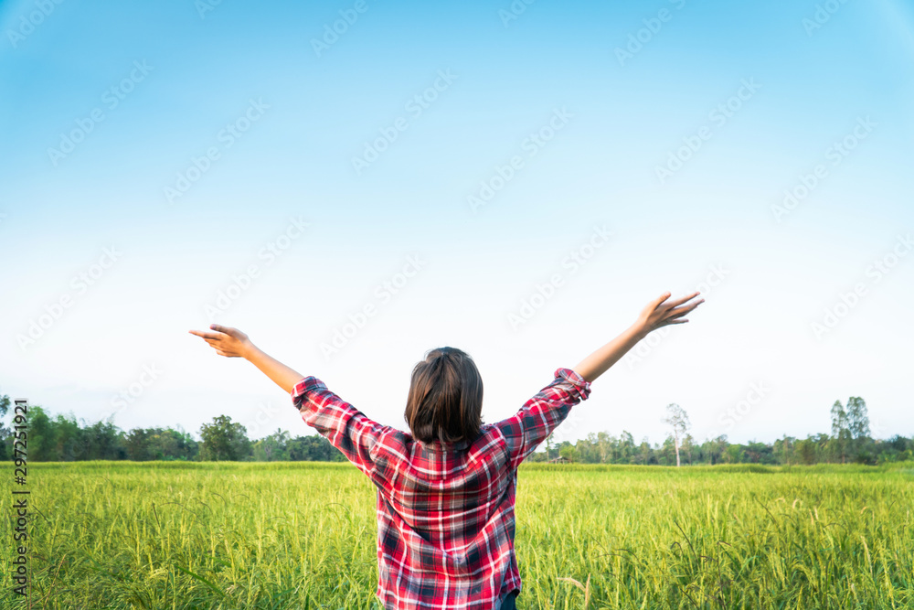 Happy moment young woman standing and open hands in rice field. Happy moment young woman standing and open hands in rice field.