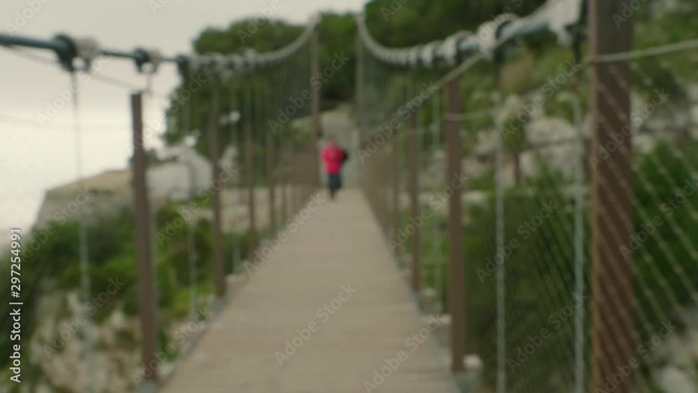 Out of focus of person crossing Windsor Suspension Bridge in Gibraltar. Out of focus of person crossing Windsor Suspension Bridge in Gibraltar.