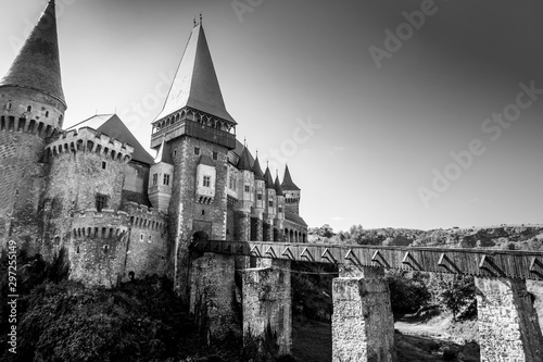Corvin Castle or Hunyadi Castle and bridge in Hunedoara, Romania. Monochrome