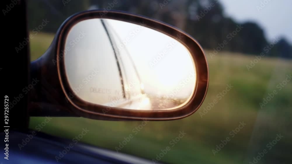 Sun reflection in the automobile mirror during drive Sun reflection in the automobile mirror during drive