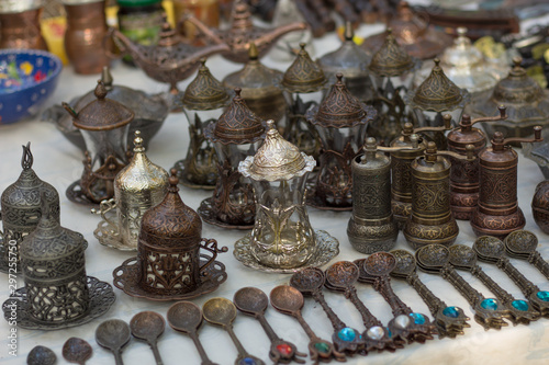 Fototapeta Naklejka Na Ścianę i Meble -  Bronze spoons, pepper mills and teapots on the counter of the Oriental Bazaar