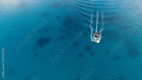 Aerial view of lonely small fishermen's boat in the middle of the ocean. Concept: freedom, wild fisherman fishing fishes in Maldives resort, Seychelles, Mauritius, Into the wild