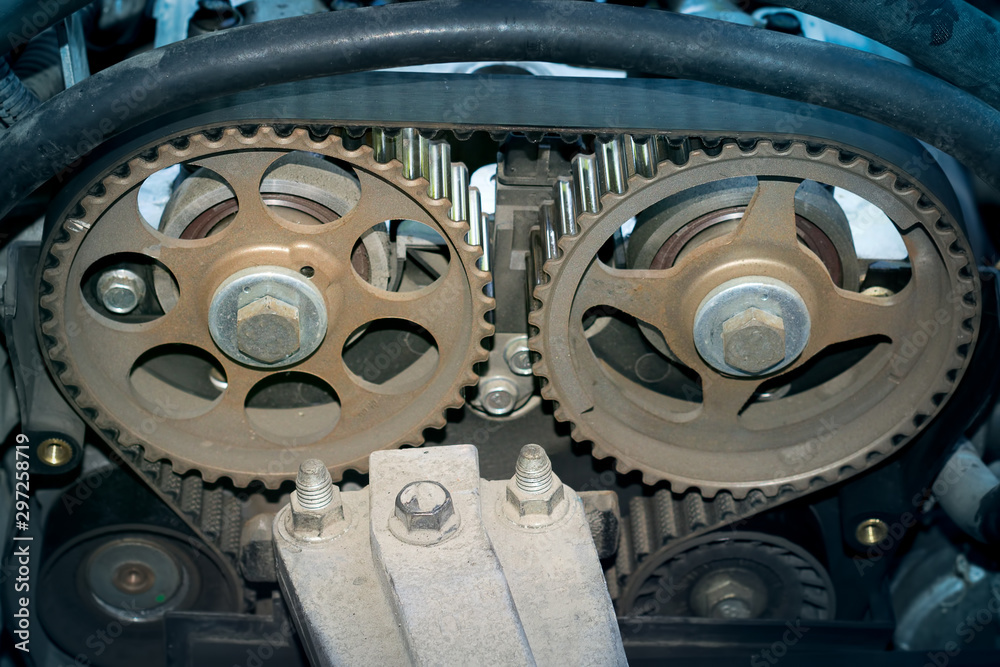 The inside of a car engine close-up on a dark background, toning, vignette