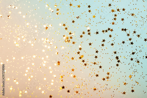 Trendy coral and blue background with gold stars. The concept of celebrations, the Day of St. Valentine, Christmas, New Year, holiday, birthday, etc.