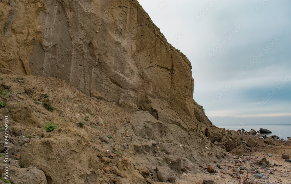 Nature background. landslide on steep coastal cliffs . Sand and clay rocks.