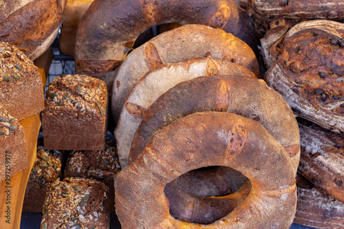 Variety of freshly baked rustic bread loaves on display on a market stall in the UK