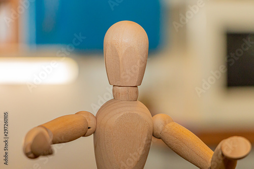 wooden mannequin holding blank card