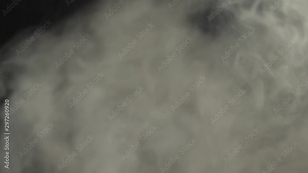 Two roasted heaps of coffee beans are thrown up towards each other through the white smoke on black background. Smoky steamy fragrant fresh flying coffee beans. Slow Motion. Two roasted heaps of coffee beans are thrown up towards each other through the white smoke on black background. Smoky steamy fragrant fresh flying coffee beans. Slow Motion.