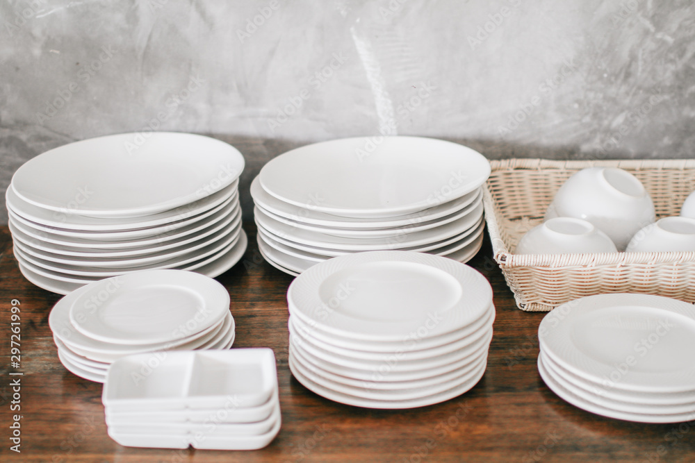Clean Dishes & Other Tableware placed on a wooden shelf Wooden shelf template isolated on white wall background which on set stacked white bowls and plates as items tableware for decorated interior or Clean Dishes & Other Tableware placed on a wooden shelf Wooden shelf template isolated on white wall background which on set stacked white bowls and plates as items tableware for decorated interior or