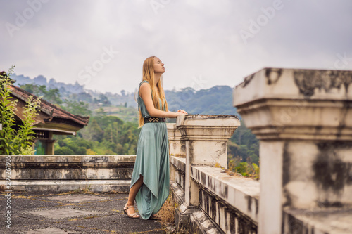 Woman tourist in abandoned and mysterious hotel in Bedugul. Indonesia, Bali Island. Bali Travel Concept