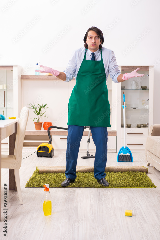 Young businessman cleaning the house