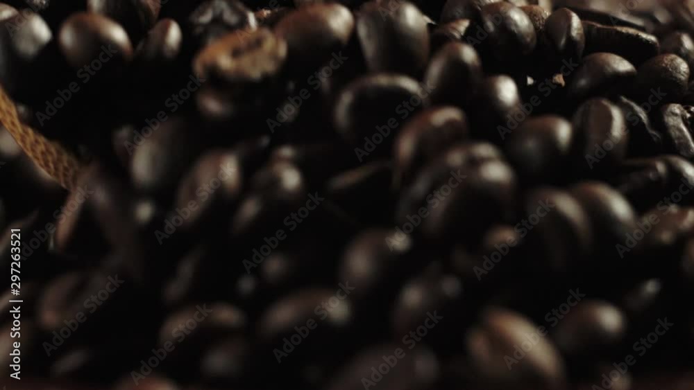Man stirring coffee beans in frying pan by wooden spoon. Steam comes from the grains. Slow motion. Man stirring coffee beans in frying pan by wooden spoon. Steam comes from the grains. Slow motion.