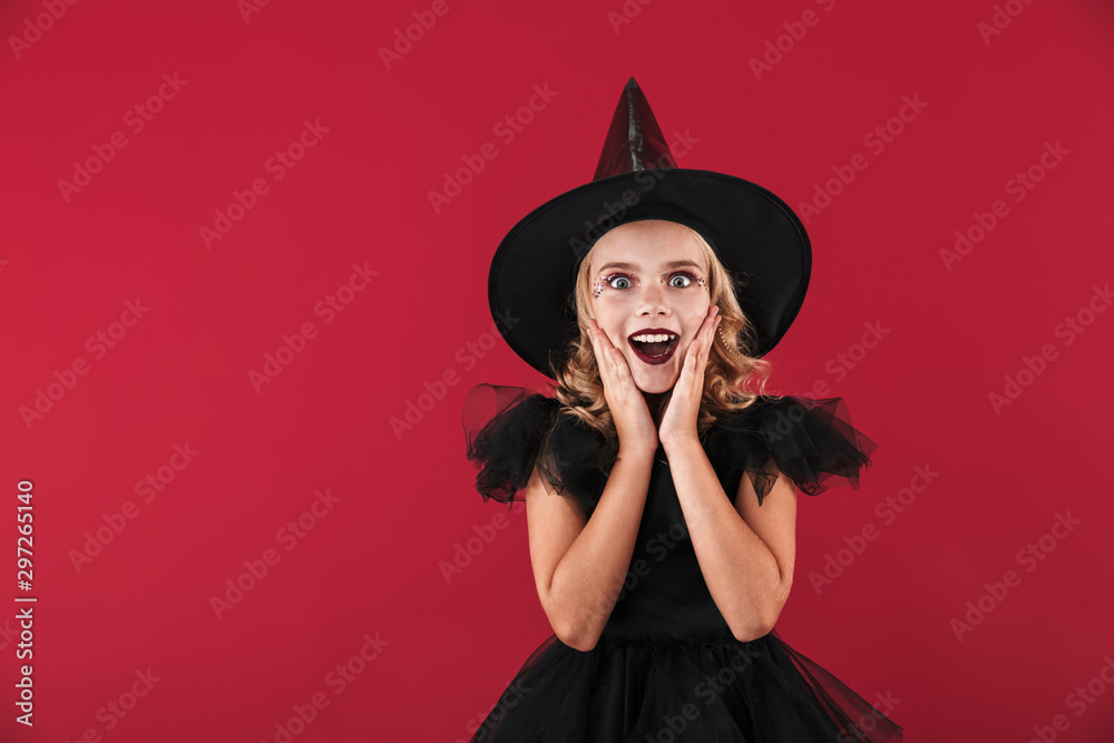Surprised little girl witch in carnival halloween costume