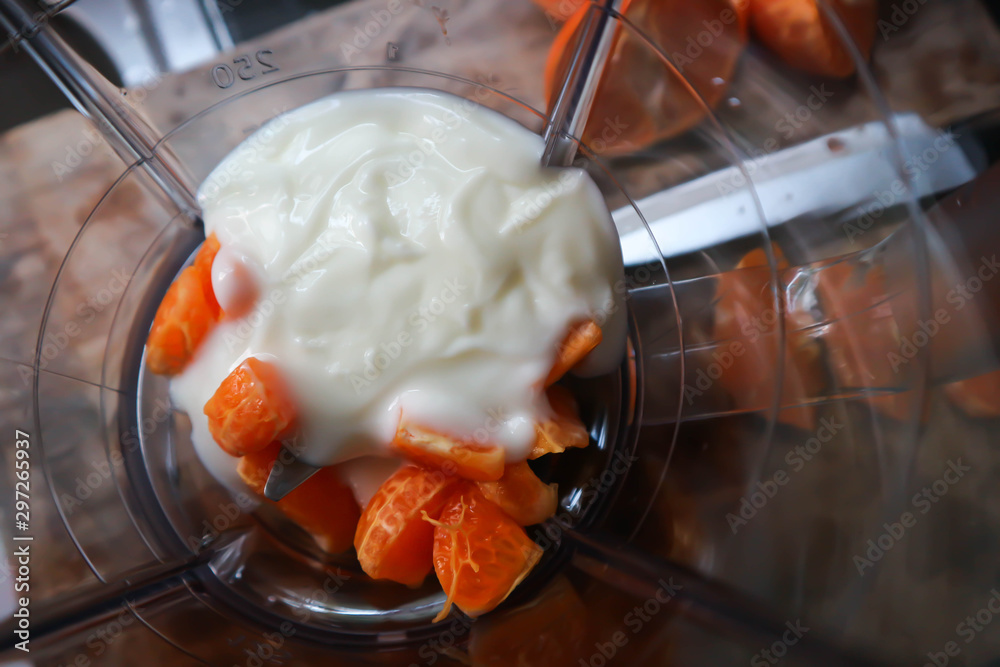 orange and yogurt in the blender, orange yogurt - obrazy, fototapety, plakaty 