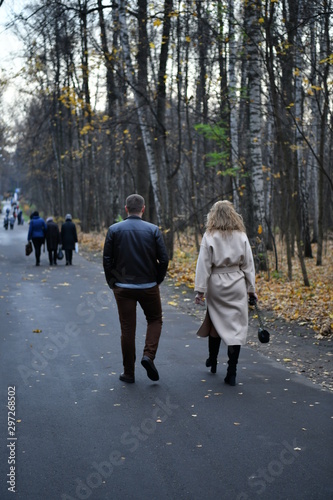 couple of young people walks in the park