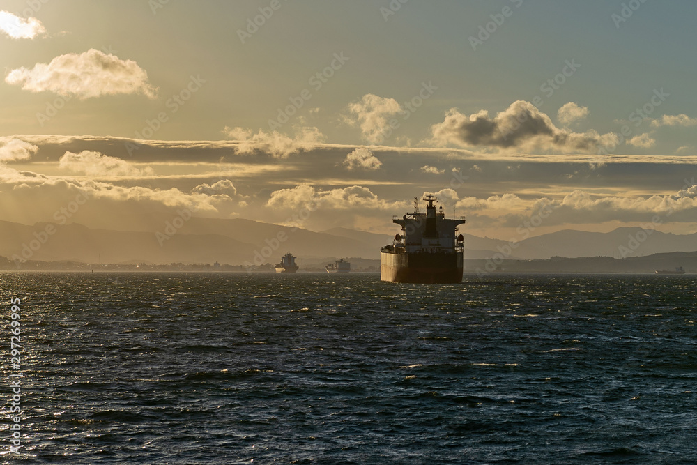 Obraz premium Cargo ship on the road at sunset. Logistics import and export business.